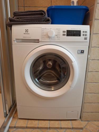 a washing machine with a blue basket on top of it at GIULIA e ANDREA in Bellano