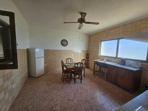 a kitchen and dining room with a table and chairs at CASA do MURO VELHO in Chão de Lamas