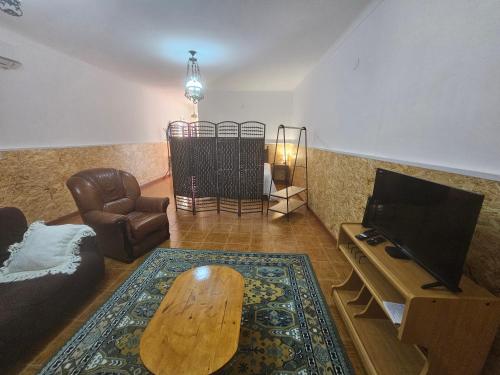 a living room with a couch and a coffee table at CASA do MURO VELHO in Chão de Lamas