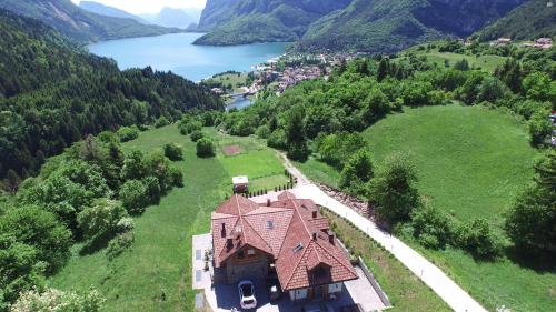 an aerial view of a house on a hill with a lake at Agriturismo Ai Castioni in Molveno
