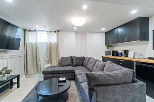 a living room with a couch and a table at Cozy and Private Basement Suite with All Amenities in Carleton Place