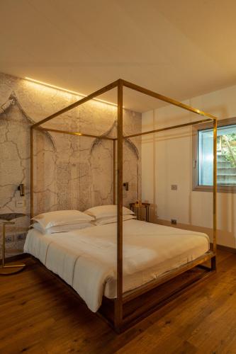 a bedroom with a canopy bed in a room at La Forestale Luxury Ecolodge B&B Primo Piano in Acqualagna
