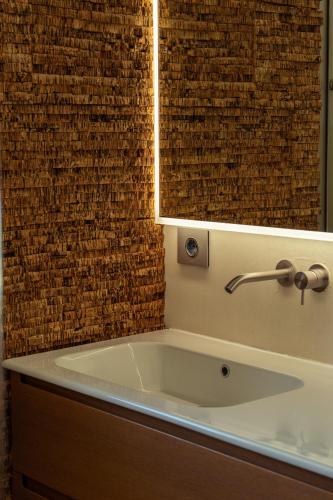a bathroom with a bath tub with a mirror at La Forestale Luxury Ecolodge B&B Primo Piano in Acqualagna
