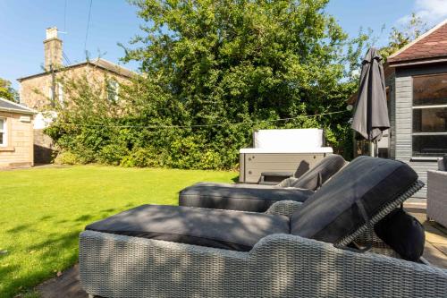 a living room with two couches and an umbrella at Burnock Lodge with Hot Tub in Ayr