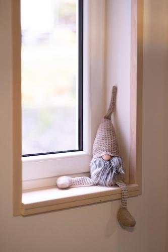 a toy gnome sitting on a window sill at CHATA LESOVNA in Pec pod Sněžkou