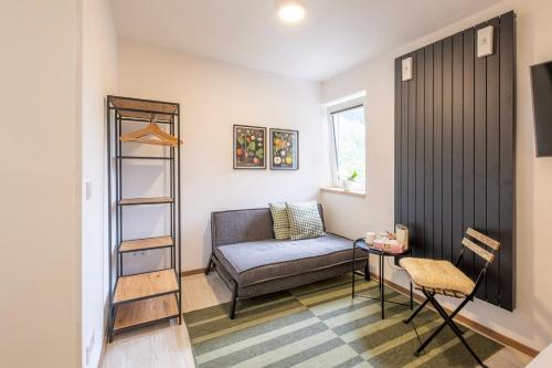 a living room with a couch and a chair at CHATA LESOVNA in Pec pod Sněžkou