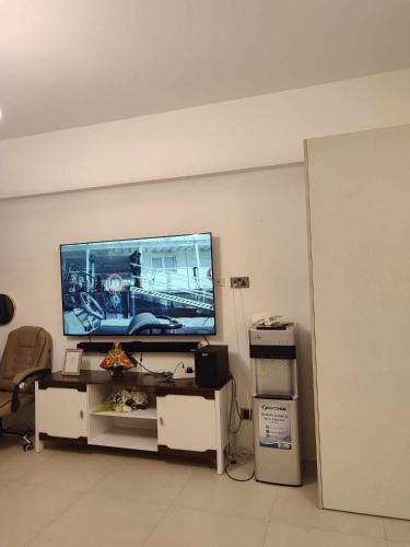 a living room with a flat screen tv on a wall at Aeon tower Davao exclusive studio unit in Davao City