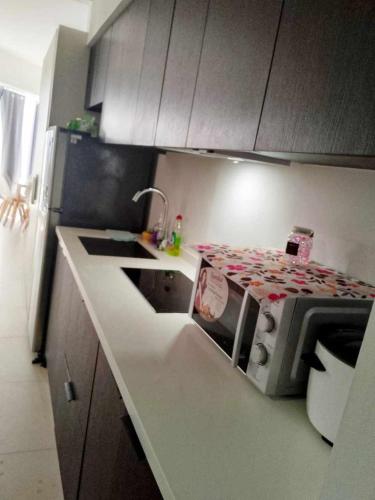 a kitchen with a counter top with a microwave at Aeon tower Davao exclusive studio unit in Davao City