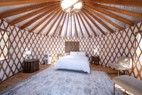 a bedroom with a bed in a yurt at EagleWatch Mountaintop Yurt in Bryson City