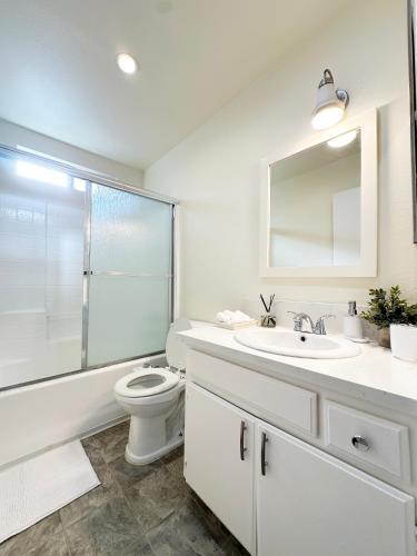 a white bathroom with a toilet and a sink at Bohemian Dream- 2BR, Retreat Near Hollywood -BR6 in Los Angeles
