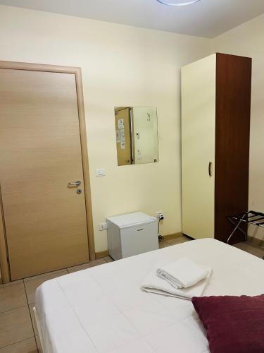 a bedroom with a bed and a door and a mirror at Cà Dei Barcaroli in Mestre