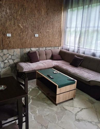 a living room with a couch and a table at -DO- Gradac in Šavnik