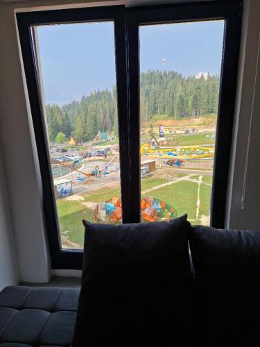 a room with a window with a view of a playground at Aparthotel Jahorinski Konaci in Jahorina