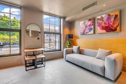 a living room with a couch and a mirror at Kings House Apartments in London