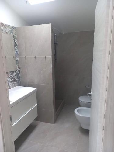 a bathroom with a toilet and a sink and a shower at Casa vacanze a due passi dal mare in Cattolica