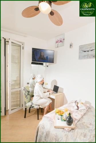 TV a/nebo společenská místnost v ubytování B&B Casaffitti