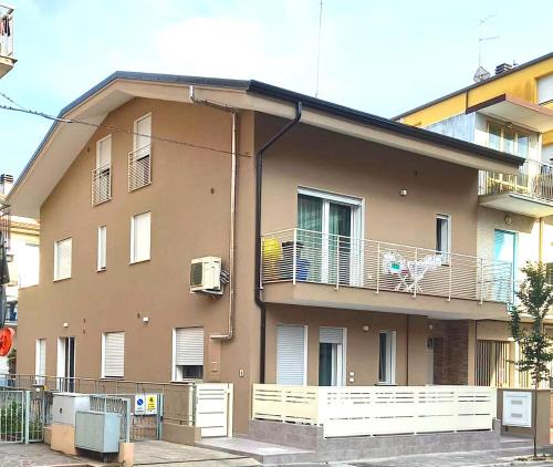 a building with a balcony on the side of it at Casa vacanze a due passi dal mare in Cattolica