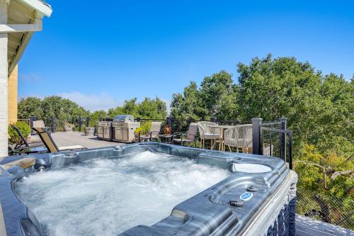 a hot tub on the patio of a house at Vallejo Home with Spacious Deck, Hot Tub and Views in Vallejo