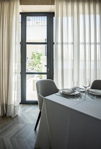 a table with wine glasses on it in front of a window at Hotel Boutique Sidonia in Jerez de la Frontera
