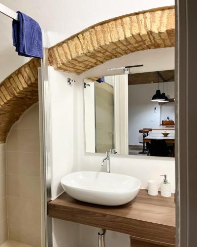 a bathroom with a white sink and a mirror at La Buona Volta in Montalbano Ionico
