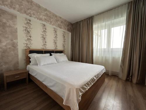 Un pat sau paturi într-o cameră la Luxury & Cosy - Infinit Apartments