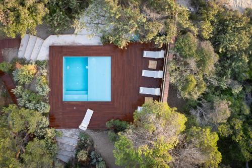 an overhead view of a house with a swimming pool at Sunset Villa in Castiglione della Pescaia