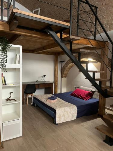 a bedroom with a bed and a loft at La Buona Volta in Montalbano Ionico