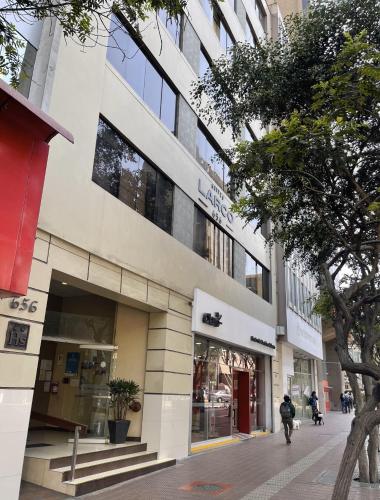 a building with people walking in front of it at Suites Larco 656 Miraflores Lima in Lima