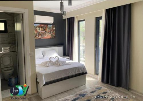 a bedroom with a bed with a bow on it at LYCIA DOLCE ViTA OLYMPOS ANTALYA in Kumluca
