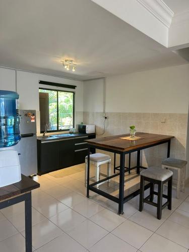 a kitchen with a table and some chairs in it at Casa Blanca R2 in Cyberjaya