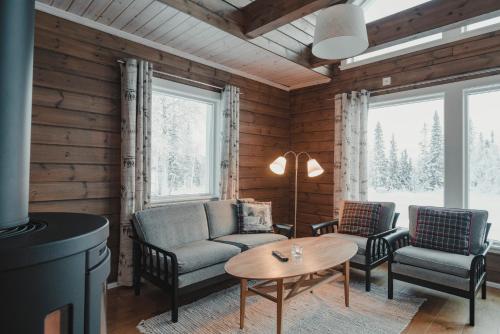 a living room with a couch and chairs and a table at Trillevallens Högfjällshotell & Lägenheter in Trillevallen