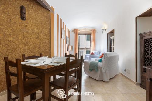 a dining room with a table and a couch at Living Villanova Apartment in Cagliari