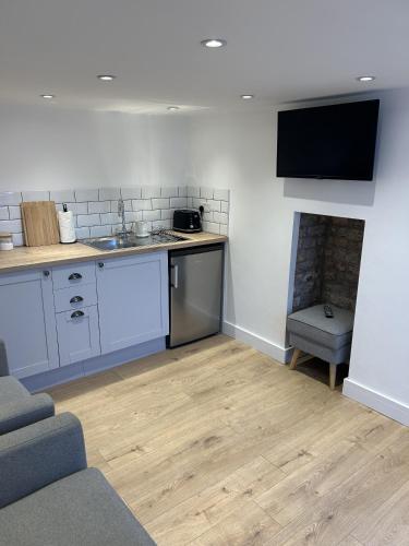 a kitchen with a sink and a counter top at UG Apartment in Bangor
