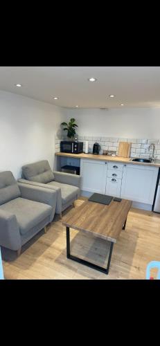 a living room with two couches and a table at UG apartment in Bangor