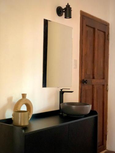 a bathroom with a sink and a mirror on a counter at Mestizo Antigua Cortijo in Ciudad Vieja