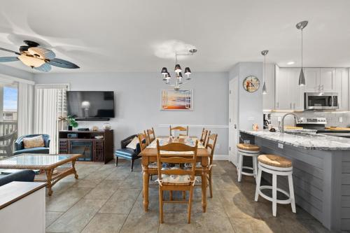 a kitchen and dining room with a table and chairs at Pelicans Watch 218 in Myrtle Beach
