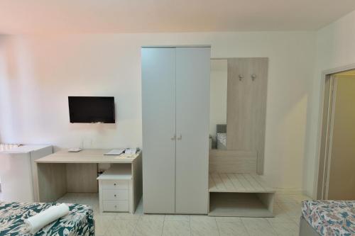 a bedroom with a desk and a computer in it at Eden Park Hotel in Marina di Campo