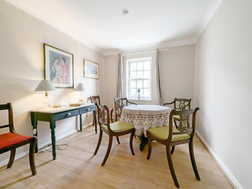 a dining room with a table and chairs at Frankland House in Emsworth