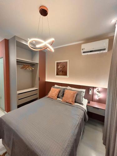 a bedroom with a bed and a ceiling fan at Studio Sunset João Pessoa in João Pessoa
