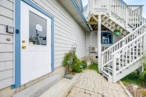 a house with a white door and a staircase at Shared Dock and Fire Pit Peaceful Surry Studio! in Surry