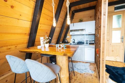 a kitchen with a wooden table and chairs in a cabin at Eka's Village in Plav