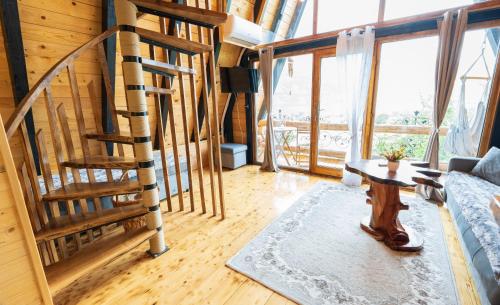 a living room with a spiral staircase in a house at Eka's Village in Plav