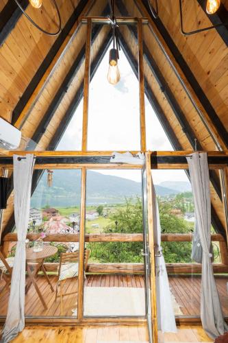 a room with a large window in a wooden building at Eka's Village in Plav