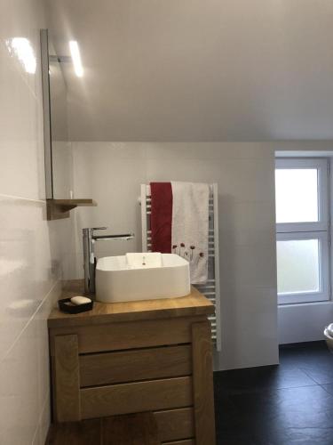 a bathroom with a sink on a wooden counter at La biche in Bonnes