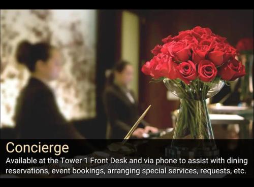 a vase of red roses sitting on a table at MGM Signature-22-711 Strip View Jacuzzi Studio in Las Vegas