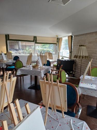 a room with chairs and tables and a room with windows at Wild Cherry Apartments in St. St. Constantine and Helena