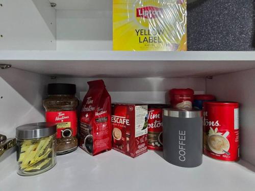 a shelf in a refrigerator with various food items at Cozy New 1 bed basement suite in Edmonton