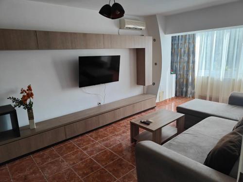 a living room with a couch and a flat screen tv at Mari's By The Sea in Mangalia