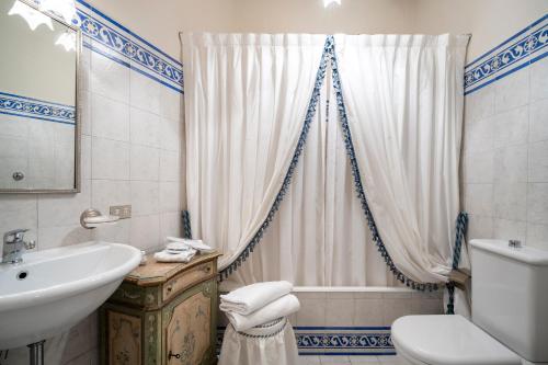 a bathroom with a sink and a toilet and a shower at Villa Poggio Bello in Florence