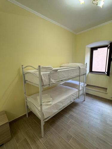 two bunk beds in a room with a window at Da Nonna Maria - Belvedere in Celano
